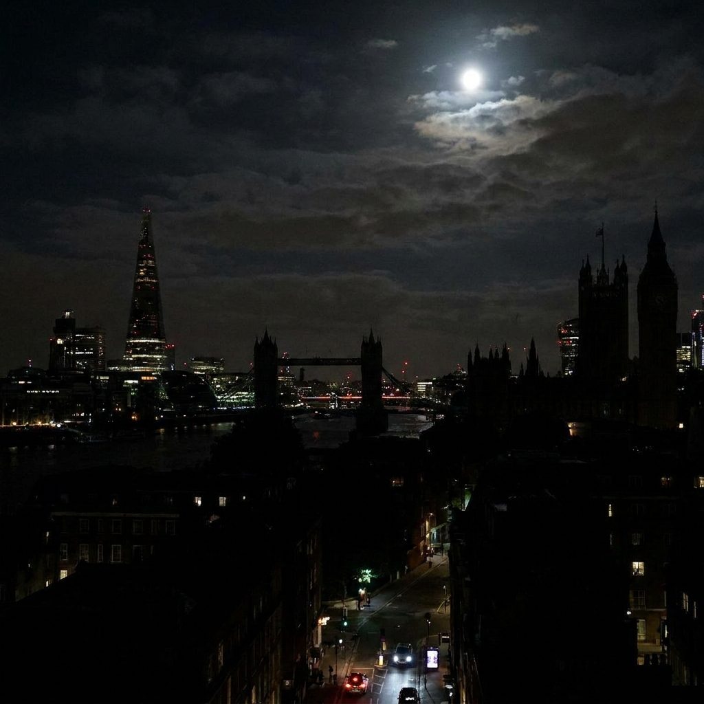 London skyline at night with some areas dark during a power cut